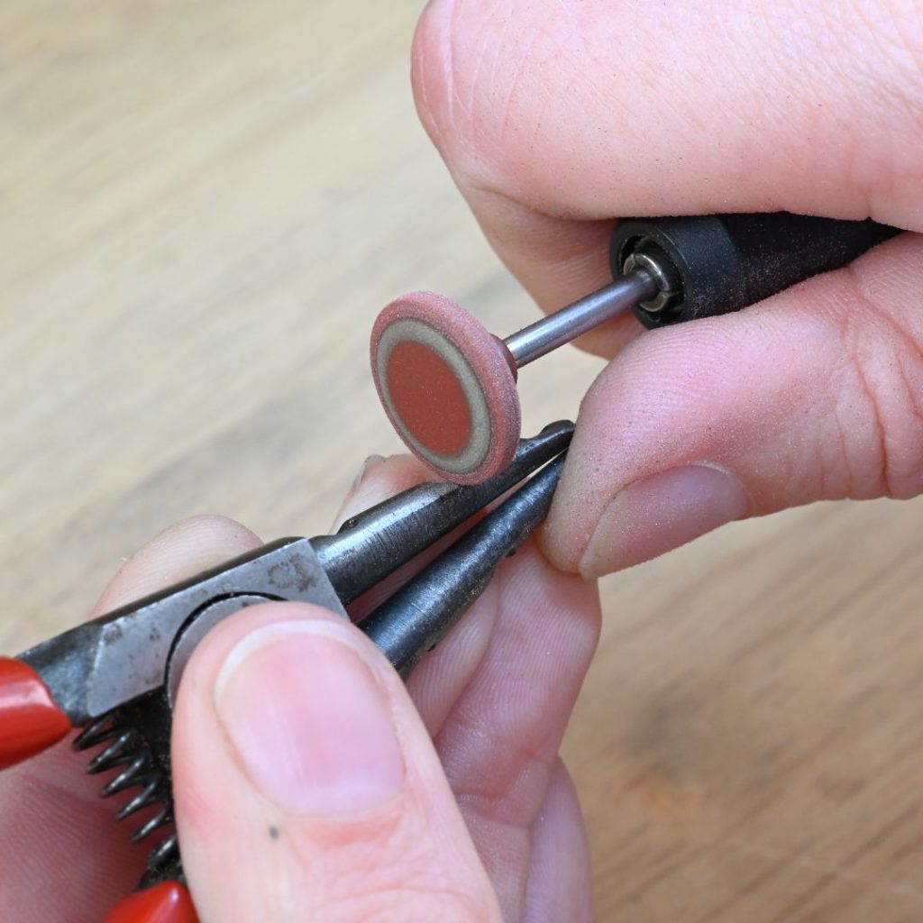 Modifying ring opening pliers with a rubber wheel for making paperclip link chain