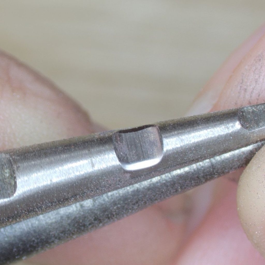 Close up image of pliers after modification with a rubber wheel