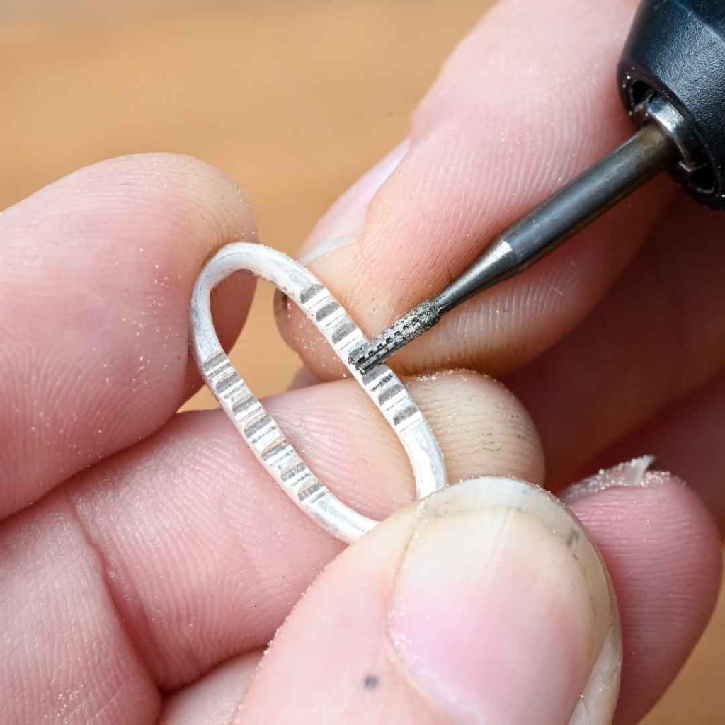 Adding texture to a sterling silver paperclip chain link using a cylinder bur