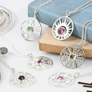 Bezel set and saw pierced sterling silver pendants. Saw frame and saw blades with fine silver bezel strip.
