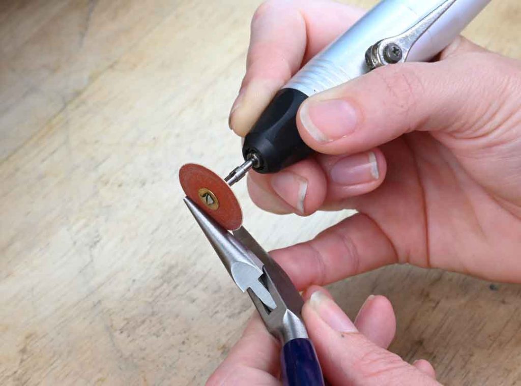 Using a sandpaper disk to modify pliers for jewellery making