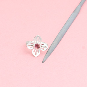 Half round needle file for jewelers and metalsmiths with handmade sterling silver flower ring with a tourmaline center stone